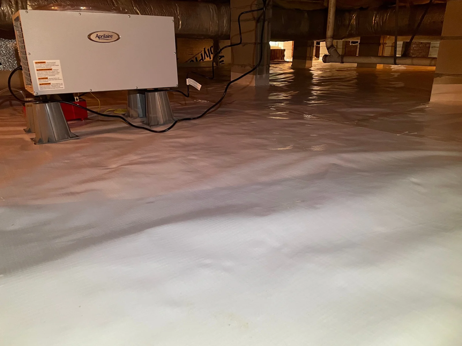 Crawl space insulation installation on walls and rim joists