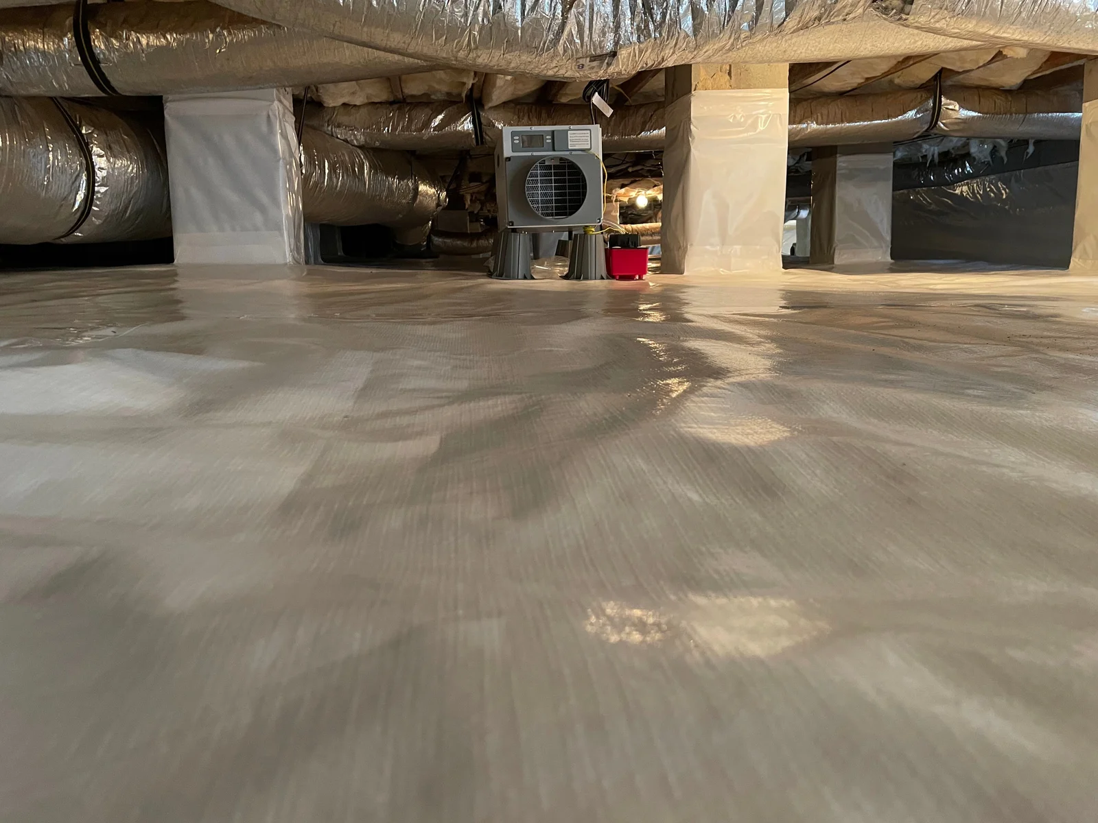 Crawl space with vapor barrier and sump pump installation