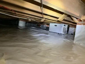 Crawl space with vapor barrier encapsulation, sealed concrete floor, and mechanical systems