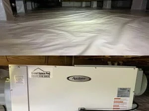 Crawl space with white vapor barrier and dehumidifier unit installed