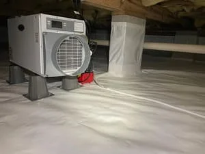 Dehumidifier and vapor barrier installed in crawl space for moisture control
