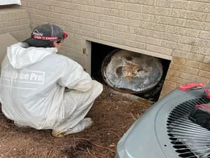 Crawl space with white vapor barrier installation and HVAC equipment