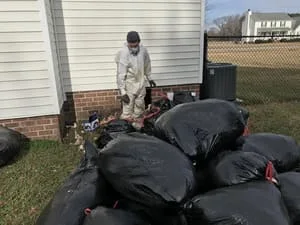 Black vapor barrier installation in crawl space with moisture control system