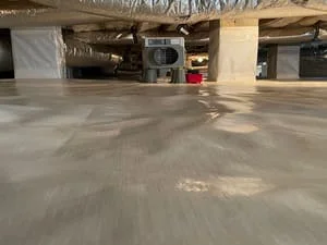 Sealed concrete crawl space floor with moisture control system and HVAC equipment