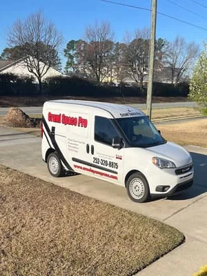 Service van parked at residential driveway for crawl space moisture control work