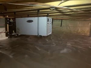 Encapsulated crawl space with vapor barrier and dehumidifier unit installed