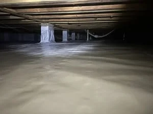Crawl space with white vapor barrier encapsulation and moisture control system installed
