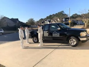 Crawl space moisture control crew with service truck and installed moisture barrier system